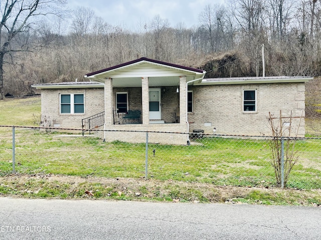 view of front of property with covered porch, a front lawn, a fenced front yard, crawl space, and brick siding