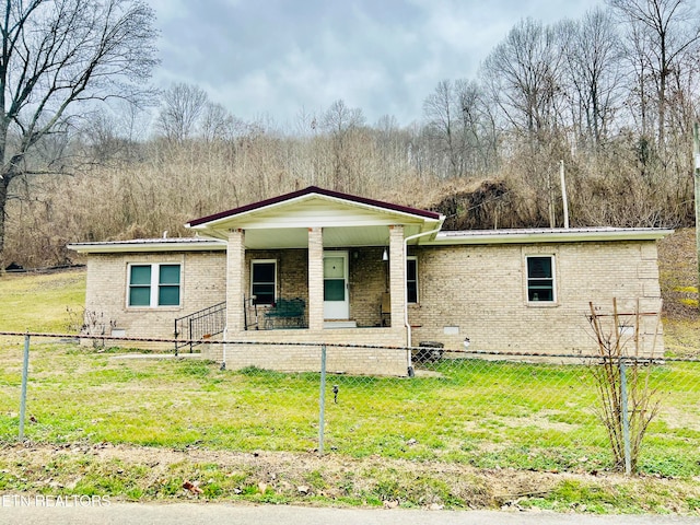 view of front of home with covered porch and a front lawn