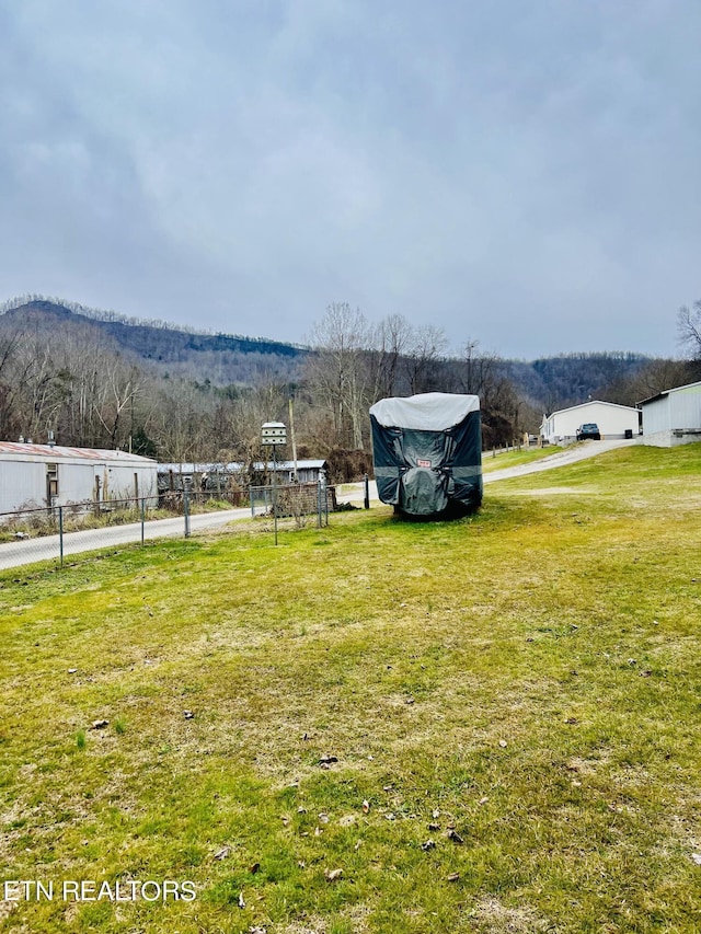 view of yard with a mountain view and fence