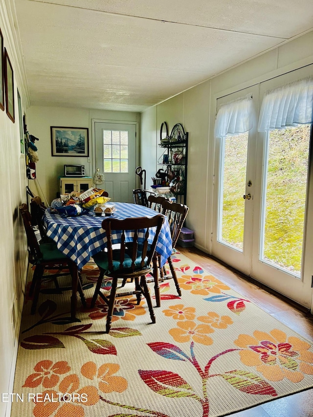 dining room featuring french doors and a textured ceiling