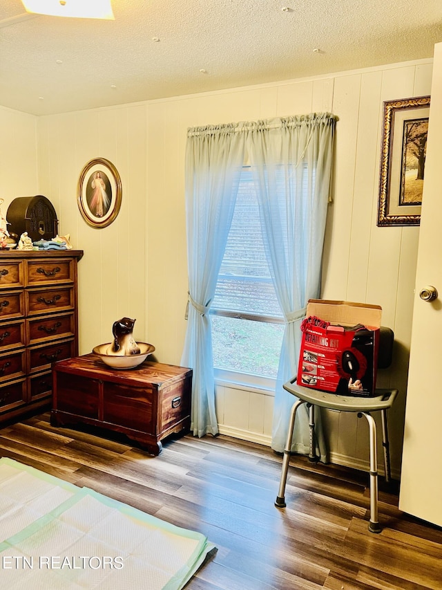 bedroom featuring a textured ceiling and wood finished floors