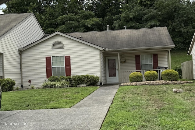 view of front of home with covered porch and a front lawn