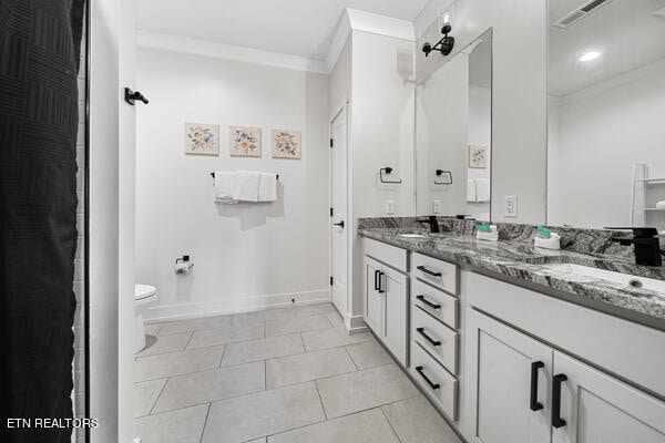 bathroom with crown molding, toilet, dual bowl vanity, and tile patterned flooring