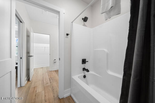 bathroom featuring shower / tub combo with curtain and wood-type flooring