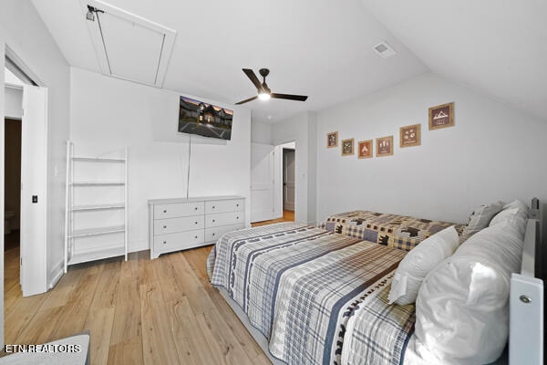 bedroom featuring ceiling fan, light wood-type flooring, and lofted ceiling