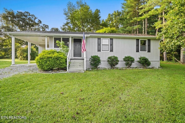 view of front facade featuring a carport and a front yard