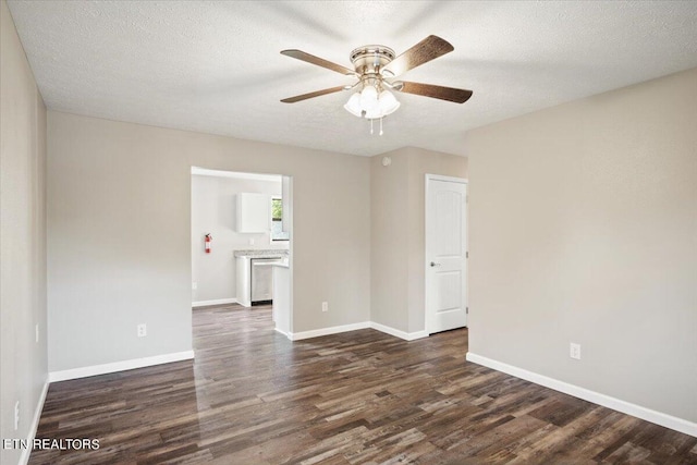 spare room with ceiling fan, dark hardwood / wood-style floors, and a textured ceiling