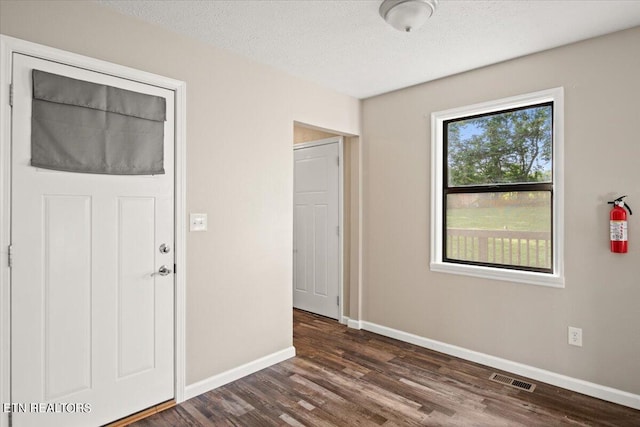 interior space featuring dark hardwood / wood-style flooring and a textured ceiling