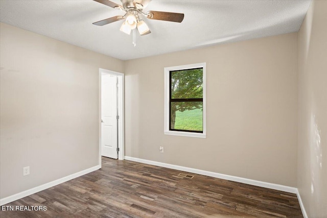 unfurnished room with ceiling fan, a textured ceiling, and dark hardwood / wood-style flooring