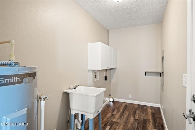 laundry area featuring sink, a textured ceiling, dark hardwood / wood-style floors, hookup for a washing machine, and water heater