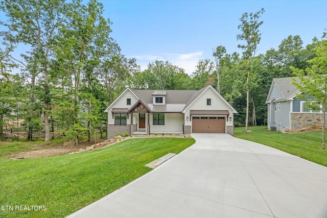 view of front of home featuring a garage, a front yard, and covered porch