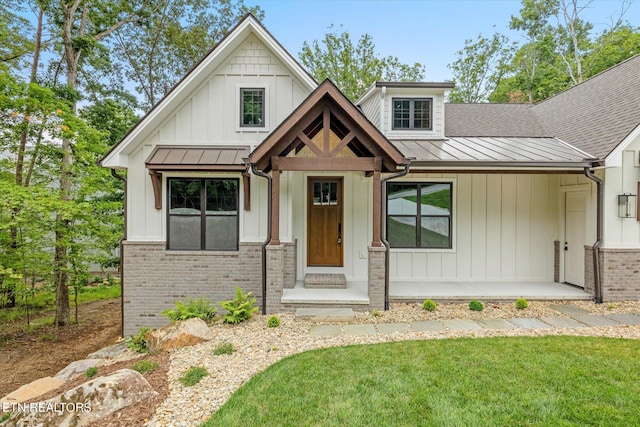 view of front of property with a front yard and covered porch