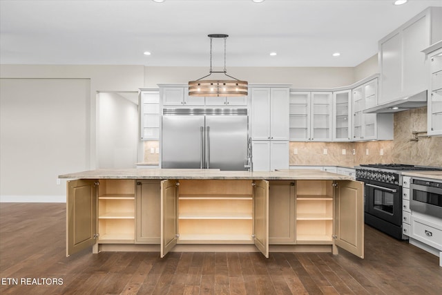 kitchen featuring backsplash, dark wood-type flooring, light stone counters, a kitchen island with sink, and stainless steel appliances