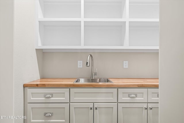bar featuring wood counters and sink