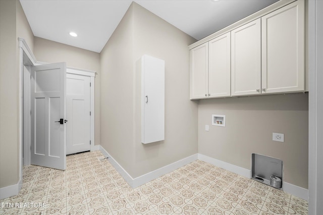 washroom with hookup for a washing machine and cabinets