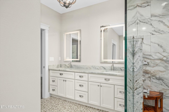 bathroom with double vanity, tile patterned floors, and a tile shower