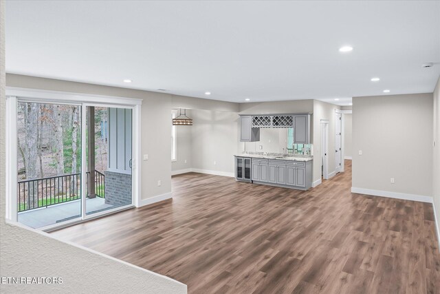 unfurnished living room featuring hardwood / wood-style flooring