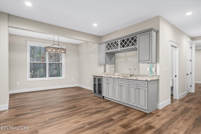kitchen with wine cooler, dark hardwood / wood-style floors, and gray cabinetry