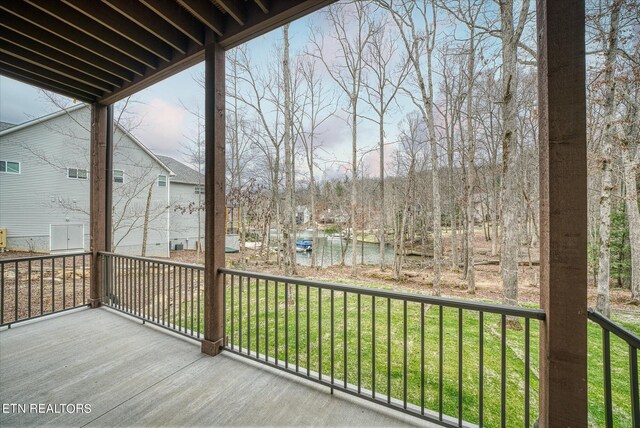 wooden terrace featuring a yard and a water view