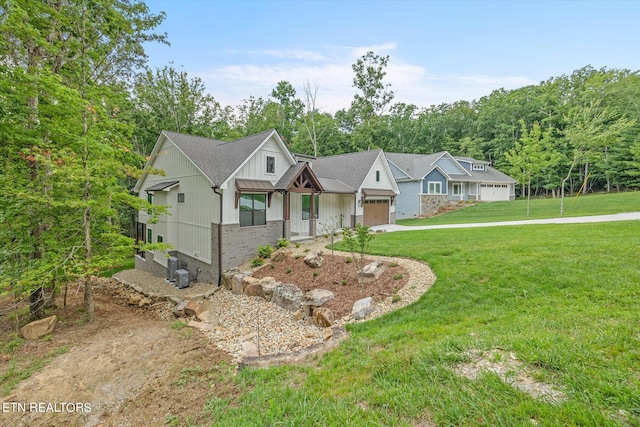 view of front of home with a garage and a front lawn