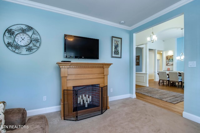 living room featuring an inviting chandelier, hardwood / wood-style floors, and crown molding