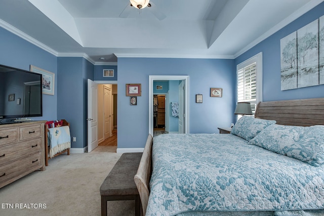 carpeted bedroom featuring ceiling fan, ornamental molding, and a tray ceiling