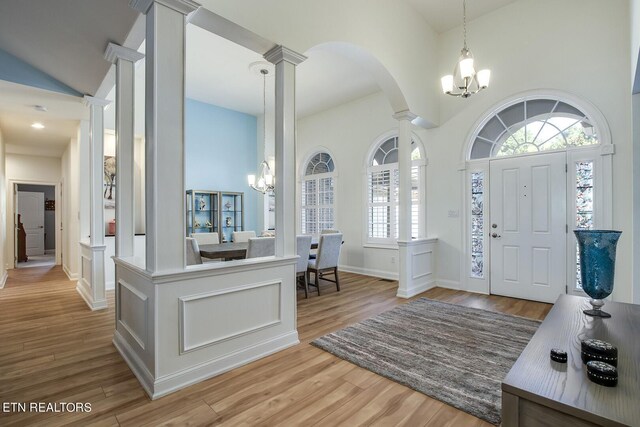 foyer featuring light hardwood / wood-style flooring, a chandelier, and a healthy amount of sunlight