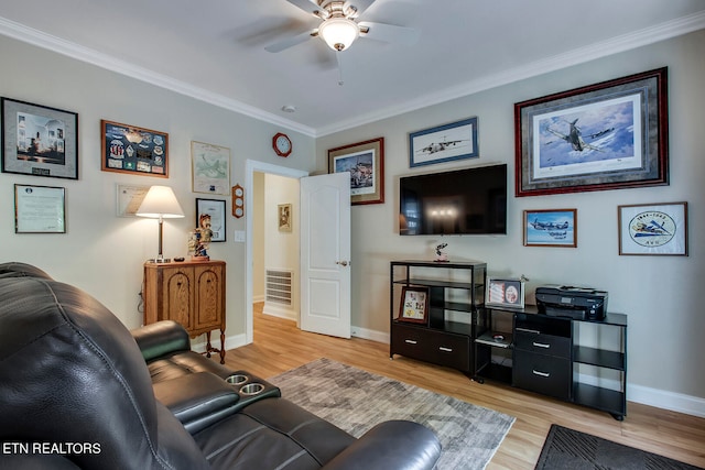 living room with ceiling fan, light wood-type flooring, and crown molding