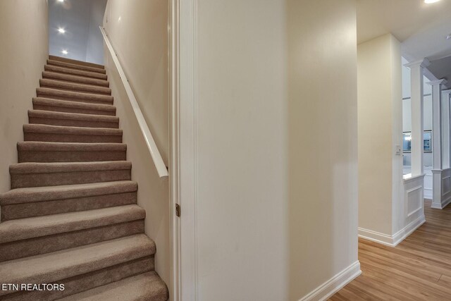 stairway featuring wood-type flooring