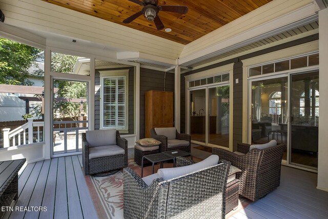 deck featuring ceiling fan and an outdoor living space