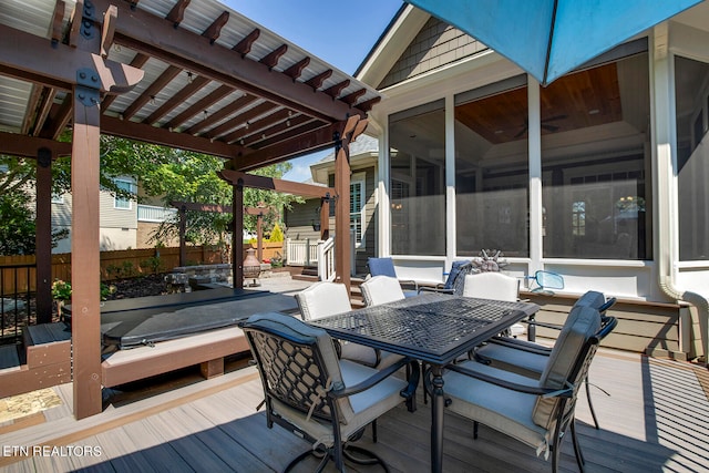 wooden terrace featuring a pergola and a sunroom