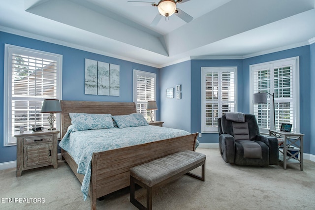 carpeted bedroom featuring ceiling fan, a raised ceiling, and ornamental molding