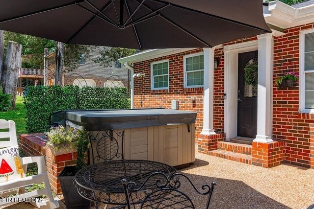 view of patio / terrace with a hot tub