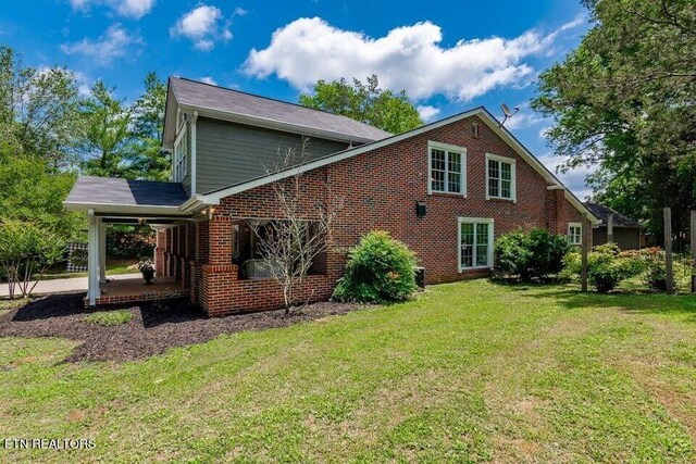 view of home's exterior featuring a patio area and a lawn