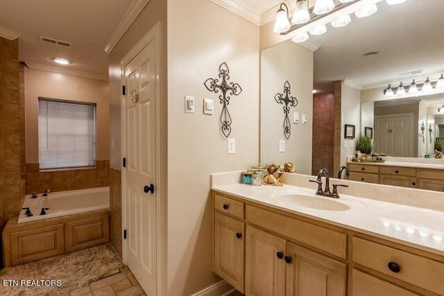 bathroom featuring vanity, ornamental molding, tile patterned flooring, and a bath