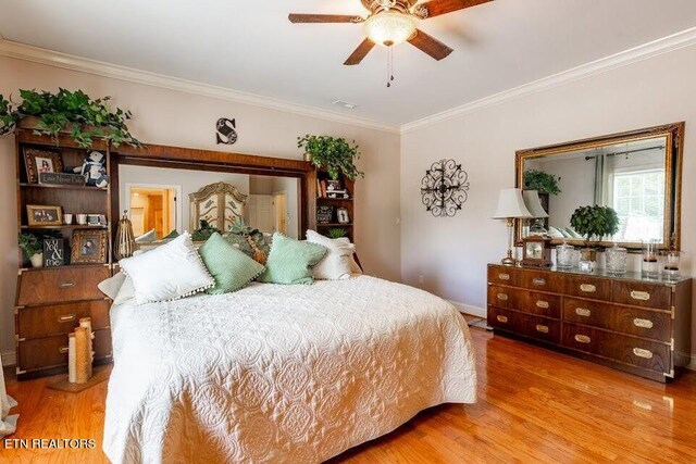 bedroom featuring ceiling fan, hardwood / wood-style flooring, and ornamental molding