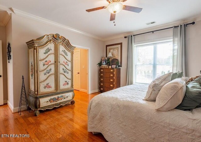 bedroom with ceiling fan, hardwood / wood-style flooring, and ornamental molding