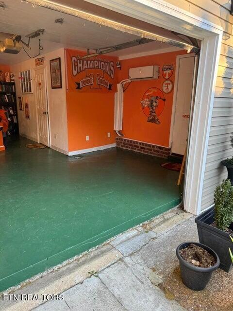 garage with a garage door opener and a wall unit AC