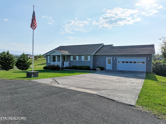 ranch-style house with a garage and a front lawn