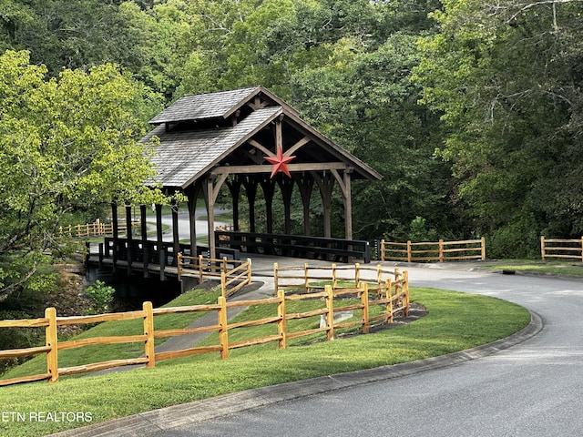 view of property's community with a gazebo and a view of trees