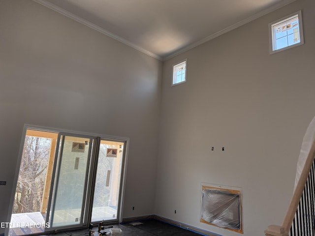 interior space featuring crown molding and baseboards