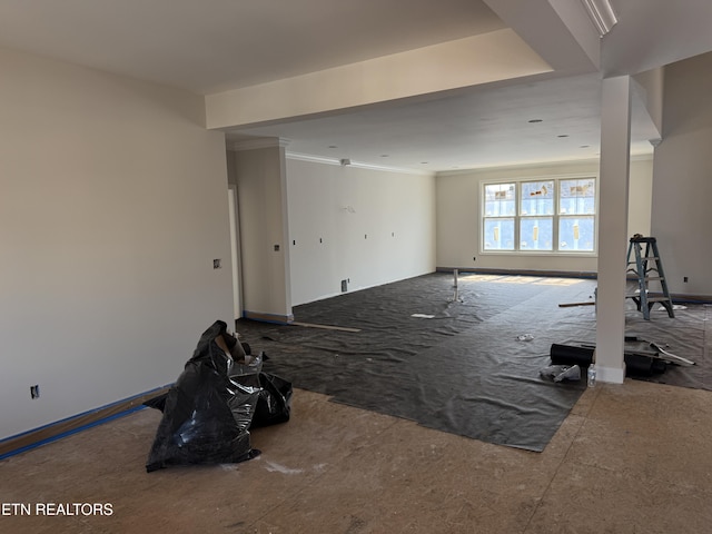 interior space with baseboards and ornamental molding