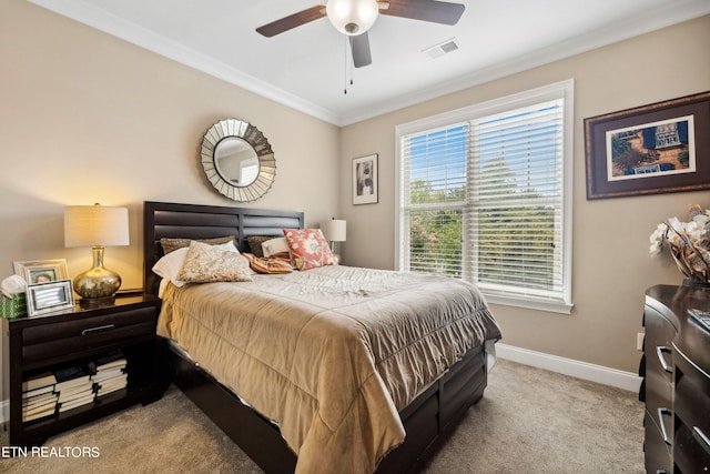 bedroom with crown molding, light colored carpet, visible vents, ceiling fan, and baseboards