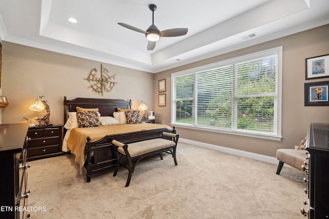 bedroom featuring light carpet, baseboards, visible vents, a raised ceiling, and a ceiling fan