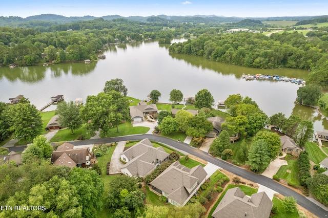 birds eye view of property featuring a water view, a forest view, and a residential view