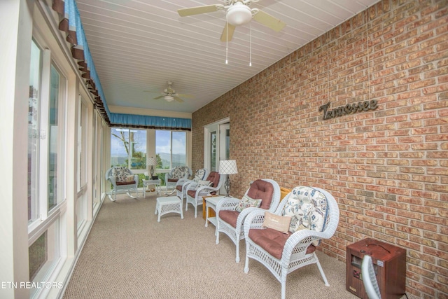 sunroom featuring ceiling fan