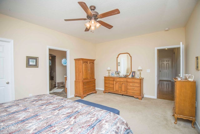 carpeted bedroom with ceiling fan and ensuite bathroom