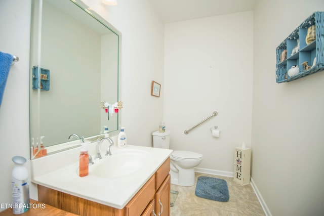 bathroom with vanity, toilet, and tile patterned flooring