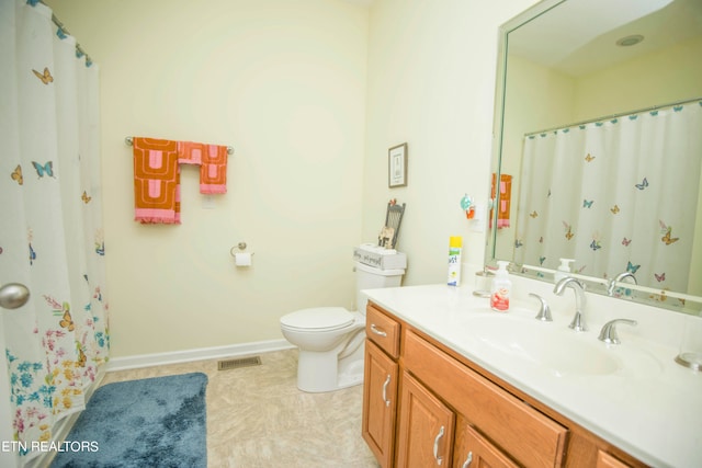 bathroom featuring vanity, toilet, and tile patterned floors