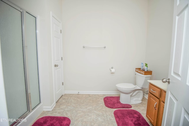 bathroom featuring vanity, walk in shower, and toilet